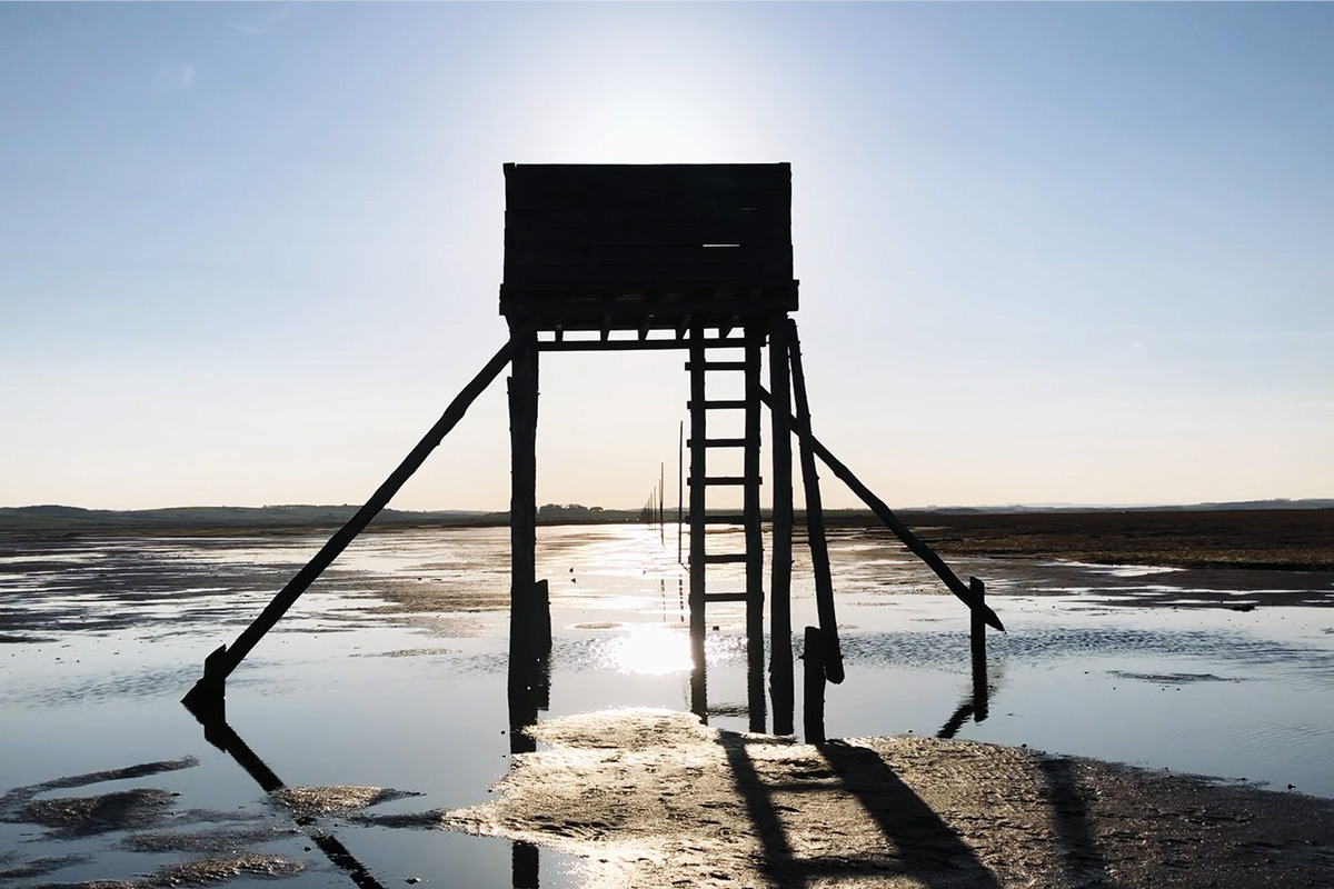 A silhouette of a refuge tower on the Pilgrim’s way to Lindisfarne from mainland.