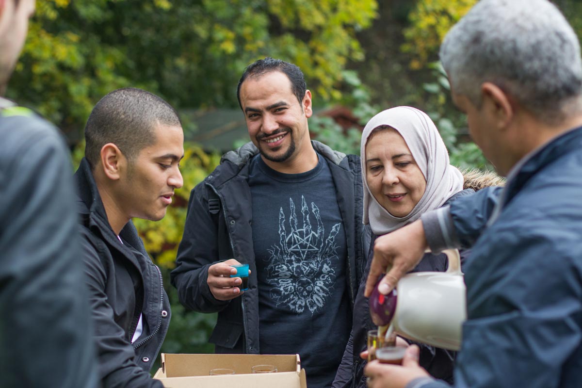 Joyful project participants sharing coffee together.