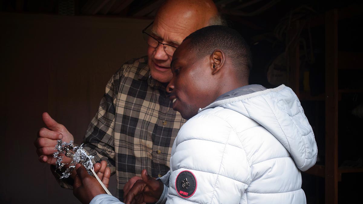 Malcolm the storyteller discussing with Ezekiel about his omen.