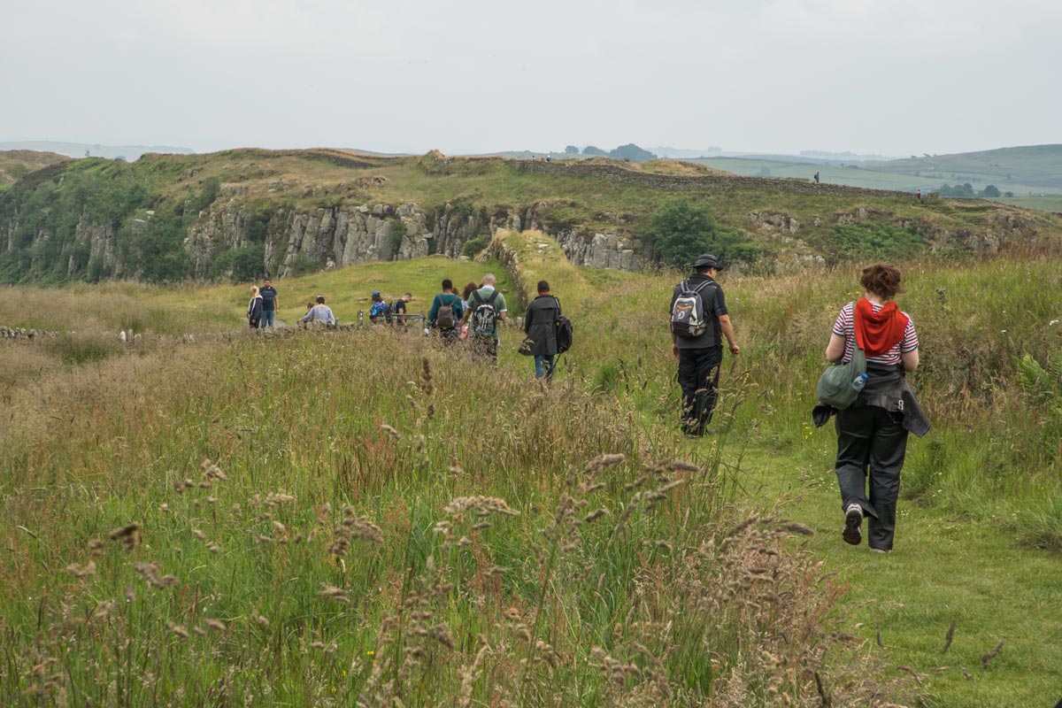 A group walking towards the Hadrian’s Wall.