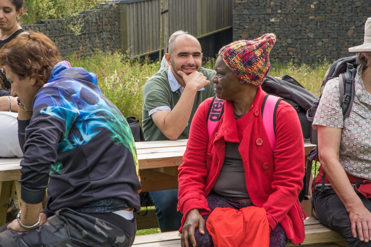 A man smiling while resting with the group at the Sill in Northumberland National Park.